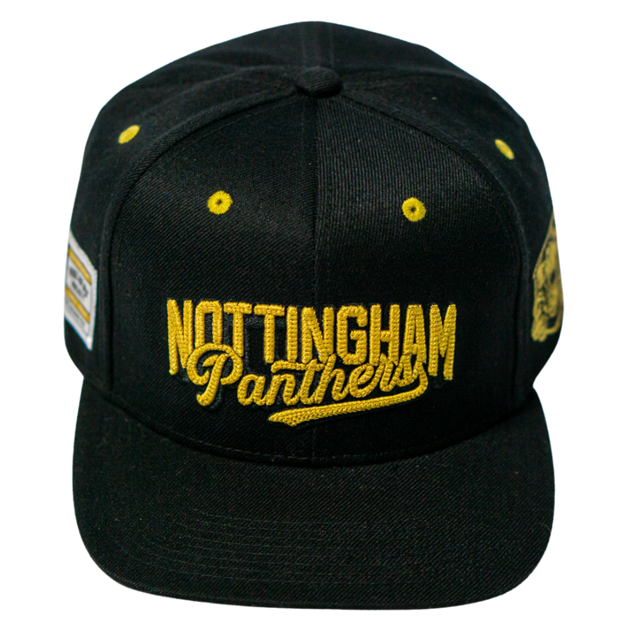 The Panthersland Nottingham Panthers 25-26 Script Snapback Cap features “Nottingham Panthers” in gold on the front, yellow ventilation holes, and two side patches—one rectangular and one with a panther logo—for a bold look.