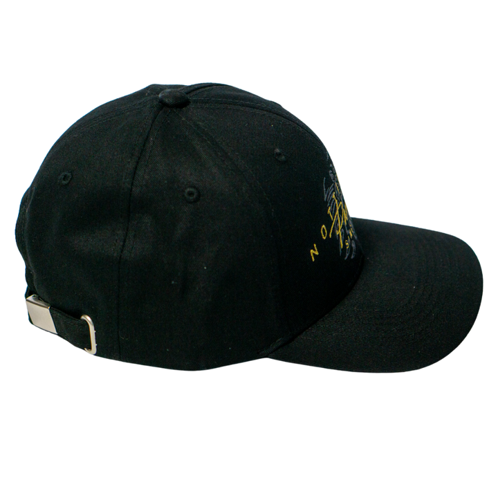 The Panthersland Nottingham Panthers Signature Cap 25-26 features a black design with a metal buckle on the adjustable strap, a slightly curved brim, and striking yellow and white embroidery on the front right side.