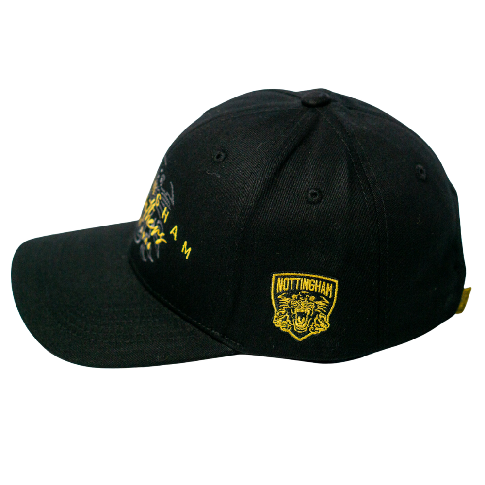 The Panthersland Nottingham Panthers Signature Cap 25-26 is a black adjustable fan cap with yellow embroidery, a lion’s head, “Nottingham” on the side, curved brim, and panel stitching for comfort and style.