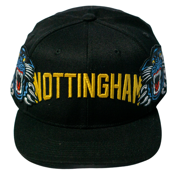 The Panthersland Nottingham Panthers 25-26 Big City Text Snapback Cap boasts bold yellow NOTTINGHAM embroidery and two blue tiger faces—an eye-catching addition to any collection.