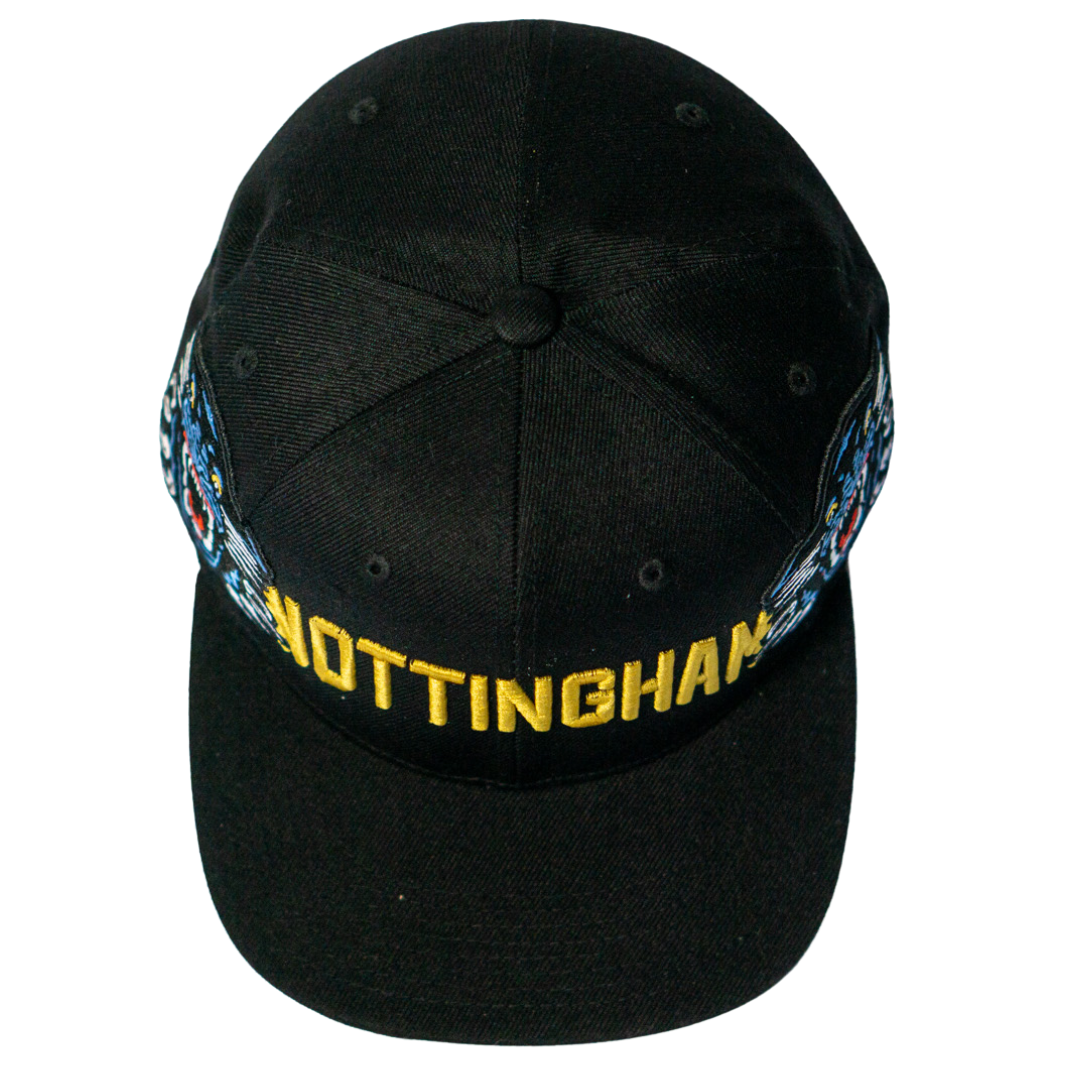 Make a statement with the Panthersland Nottingham Panthers 25-26 Big City Text Snapback Cap, featuring bold NOTTINGHAM embroidery in yellow and vibrant side designs. Presented from above for a standout look.