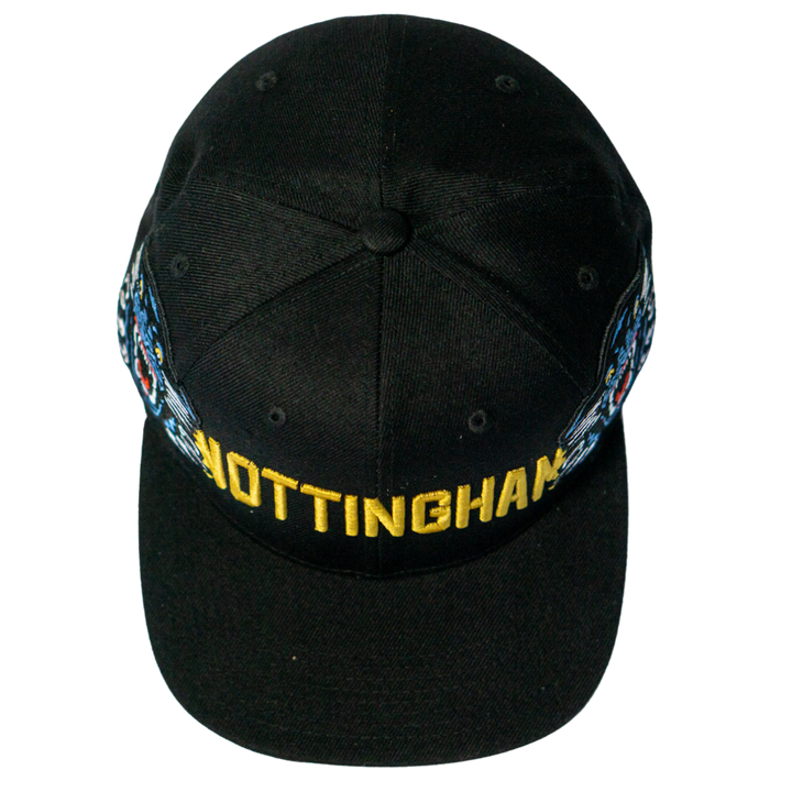Make a statement with the Panthersland Nottingham Panthers 25-26 Big City Text Snapback Cap, featuring bold NOTTINGHAM embroidery in yellow and vibrant side designs. Presented from above for a standout look.
