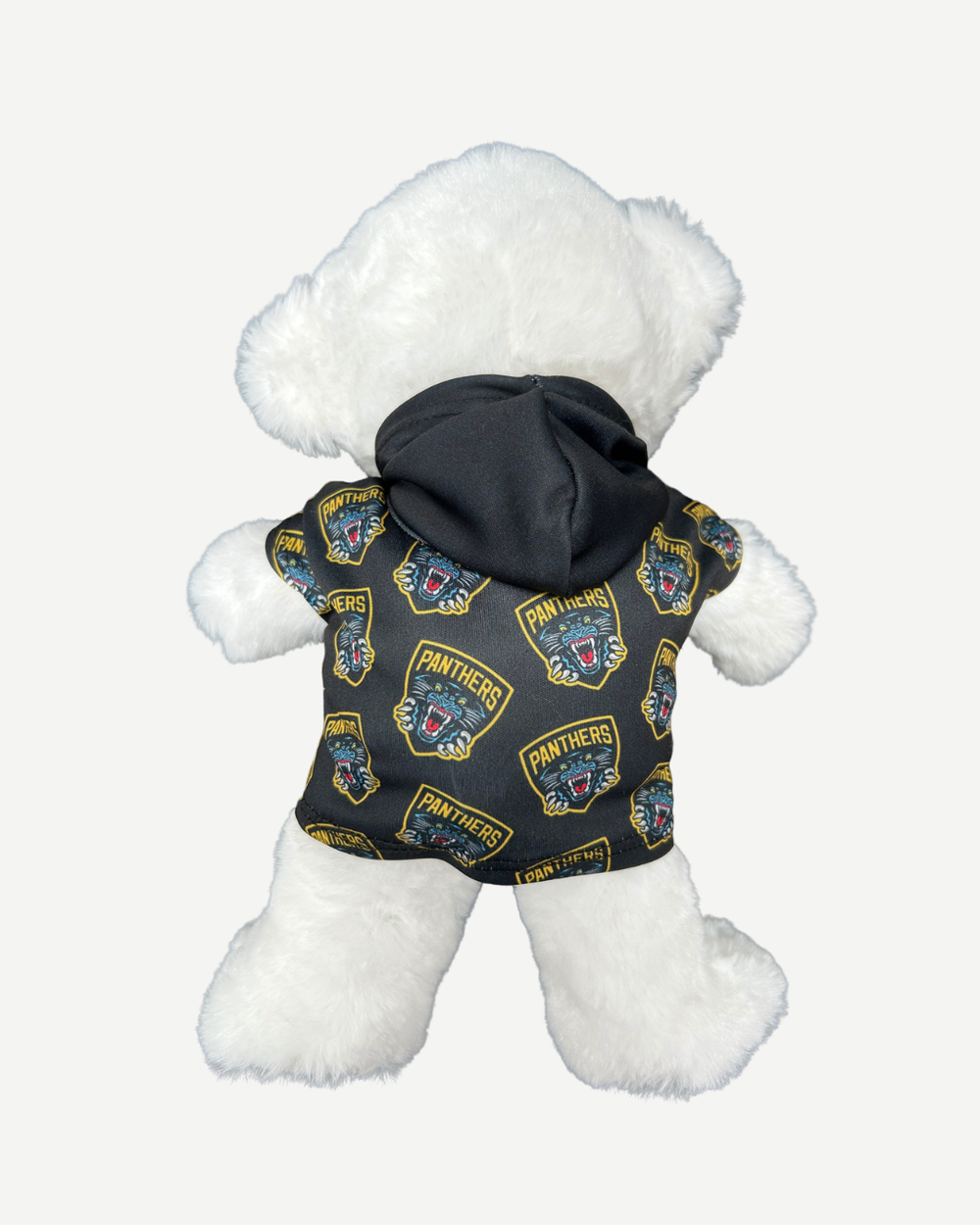White teddy bear wearing a black jacket with logos on a white background