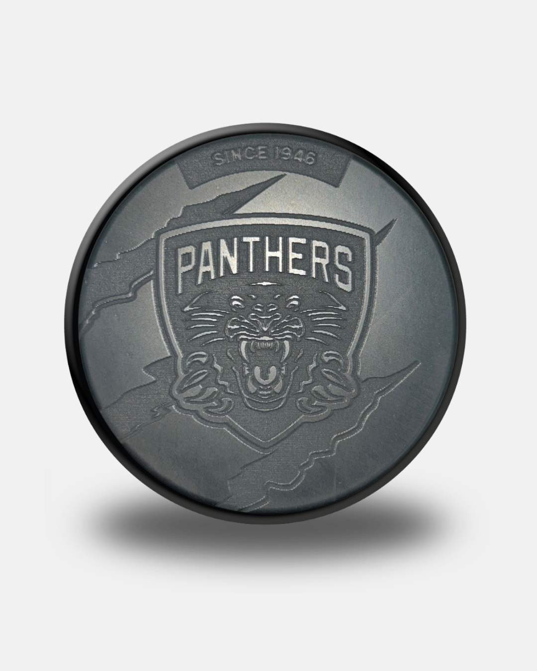 A Nottingham Panthers 26-27 Engraved Slash Puck by Panthersland, featuring a black design with a roaring panther logo, “PANTHERS,” and “SINCE 1946” above the emblem, displayed on a light gray background.