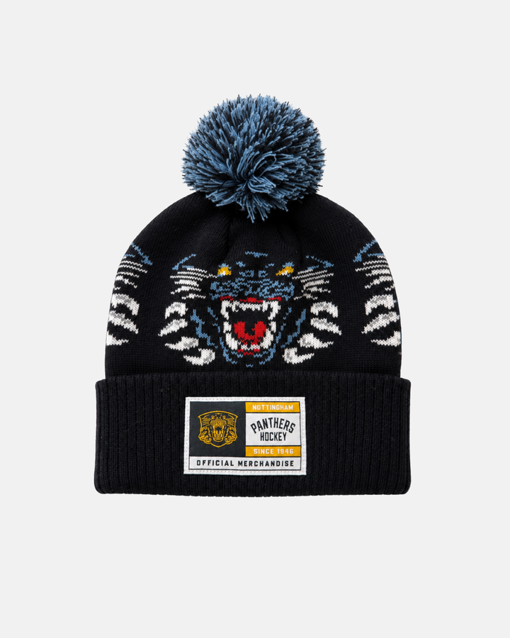 The Panthersland 26-27 Jacquard Pom Knit is a black beanie with a blue and white pom-pom, featuring an embroidered tiger face and a “Panthers Hockey Official Merchandise” patch. This stylish beanie proudly displays the iconic Nottingham Panthers logo, making it an essential accessory for dedicated fans.
