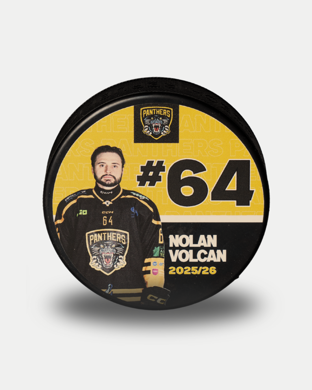 The Nottingham Panthers 2025-26 Panthers Player Puck is a limited edition featuring Nolan Volcan in a black jersey, number 64, the team logo, and "Nolan Volcan 2025/26" on a yellow background.