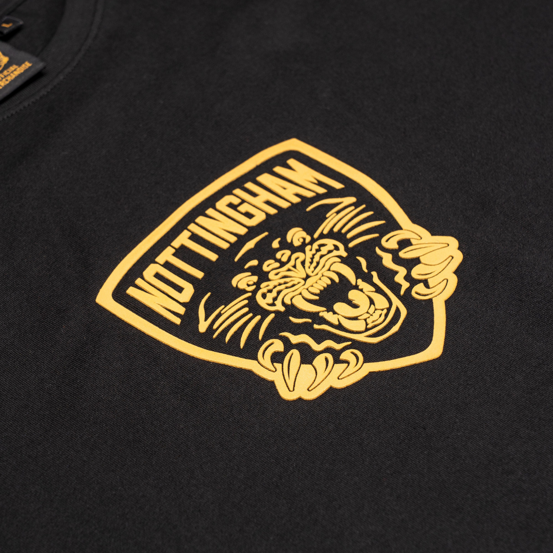 The Panthersland Kids Nottingham Panthers T-shirt Black Large Backprint 25-26 features a yellow NOTTINGHAM badge above a roaring panther—perfect for kids who love bold, fearless style.