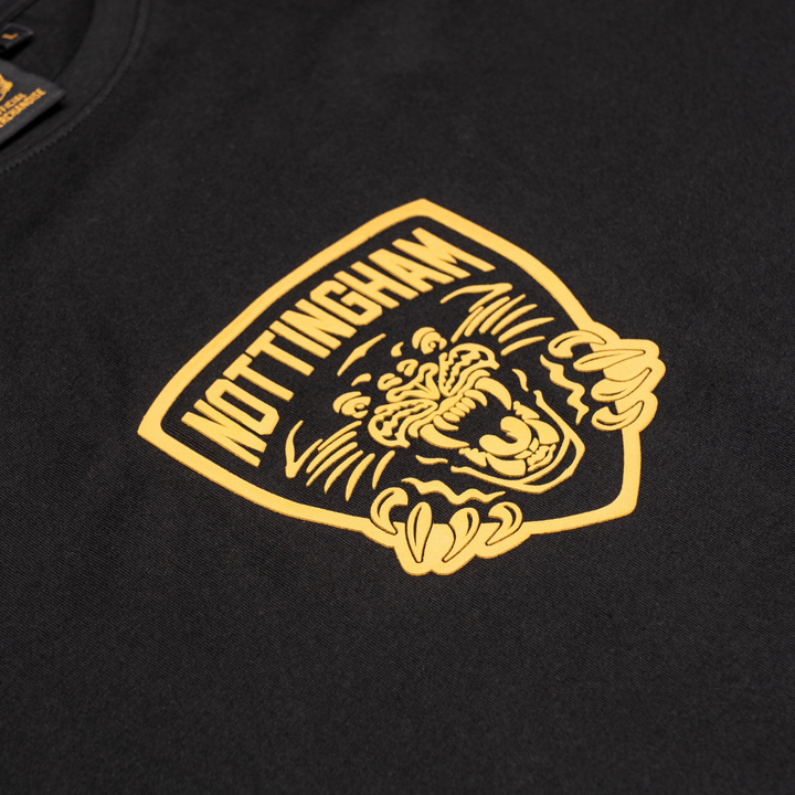The Panthersland Kids Nottingham Panthers T-shirt Black Large Backprint 25-26 features a yellow NOTTINGHAM badge above a roaring panther—perfect for kids who love bold, fearless style.
