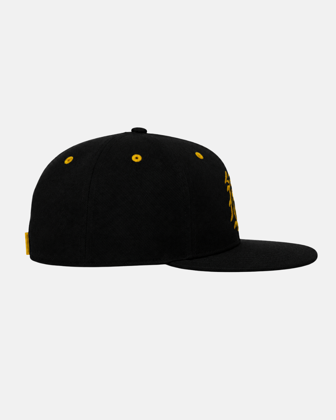 A black 26-27 Crest Snapback Cap by Panthersland, featuring a flat bill, yellow eyelets, and a small yellow tag on the left side, is shown from the left view. This stylish Nottingham Panthers cap is ideal for fans wanting to display their support. The background is plain white.