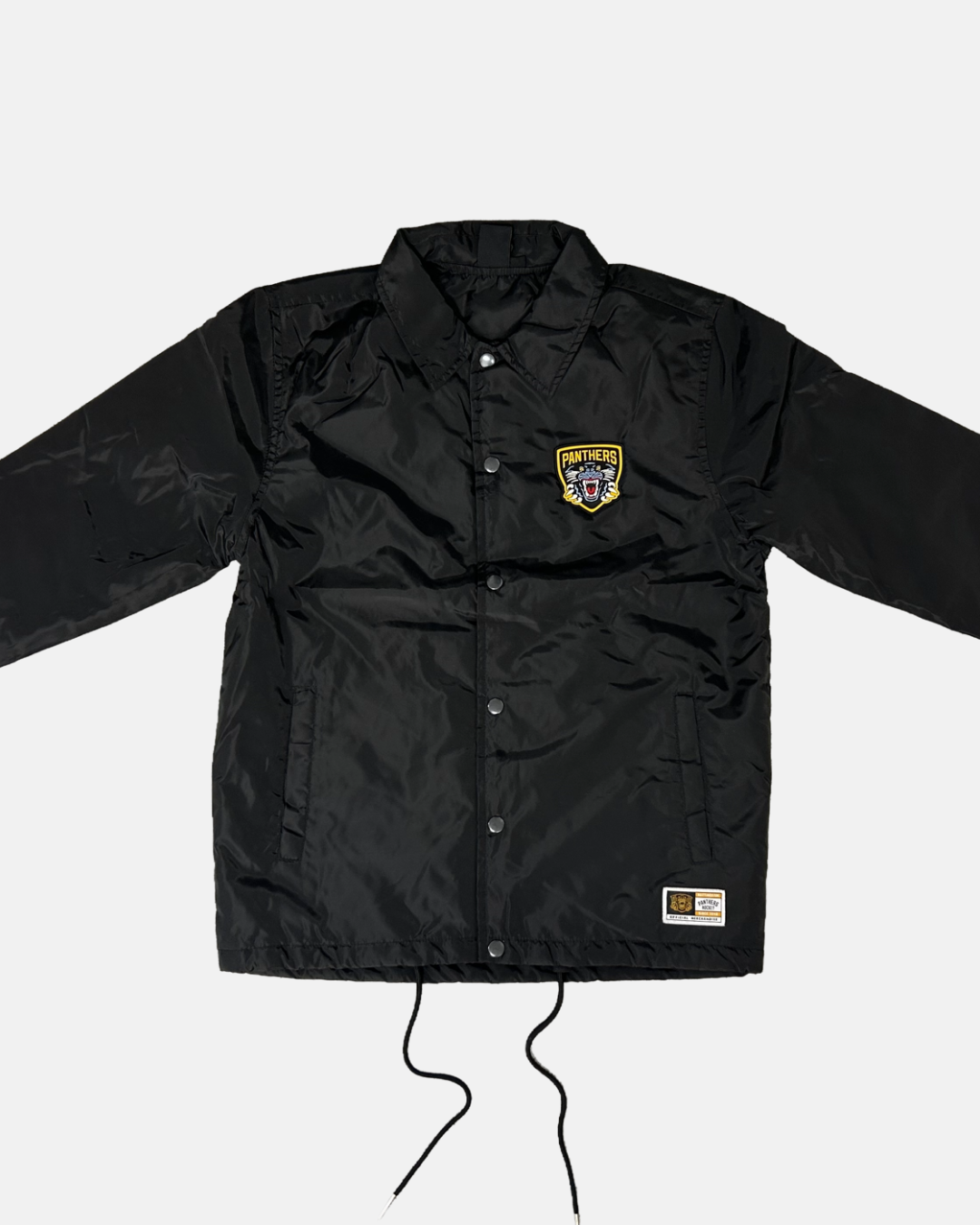 Introducing the Panthersland 26-27 Slice Coach Jacket—a black button-up coach jacket featuring a yellow Nottingham Panthers patch on the left chest and a small rectangular label near the bottom hem. This jacket includes front pockets, black drawstrings at the bottom, and classic coach jacket styling.