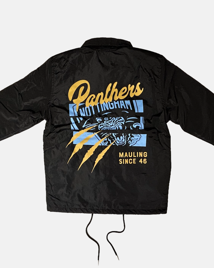 The Panthersland 26-27 Slice Coach Jacket is a black coach jacket featuring “Panthers Nottingham” in yellow and blue, a bold panther face graphic, three striking yellow claw marks, and “Mauling Since 46” printed on the back. The look is finished with a premium silicone crest for standout detail.