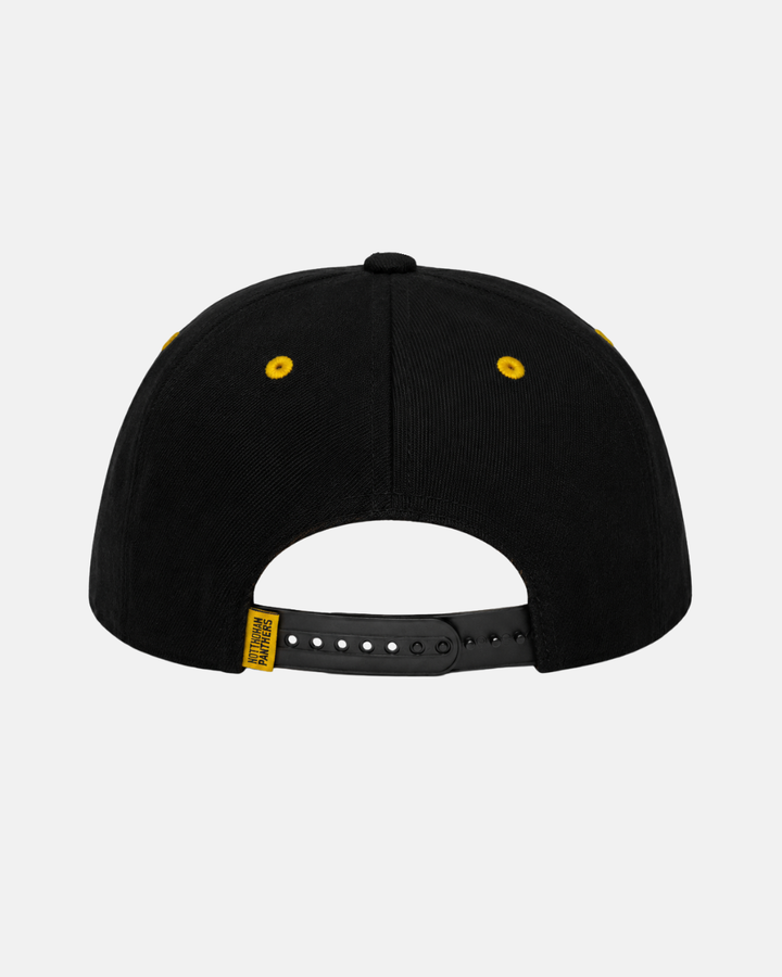 The Panthersland 26-27 Crest Snapback Cap is shown from the back, featuring yellow eyelets, an adjustable black snapback closure, and a small yellow tag on the left side. The background is plain white.