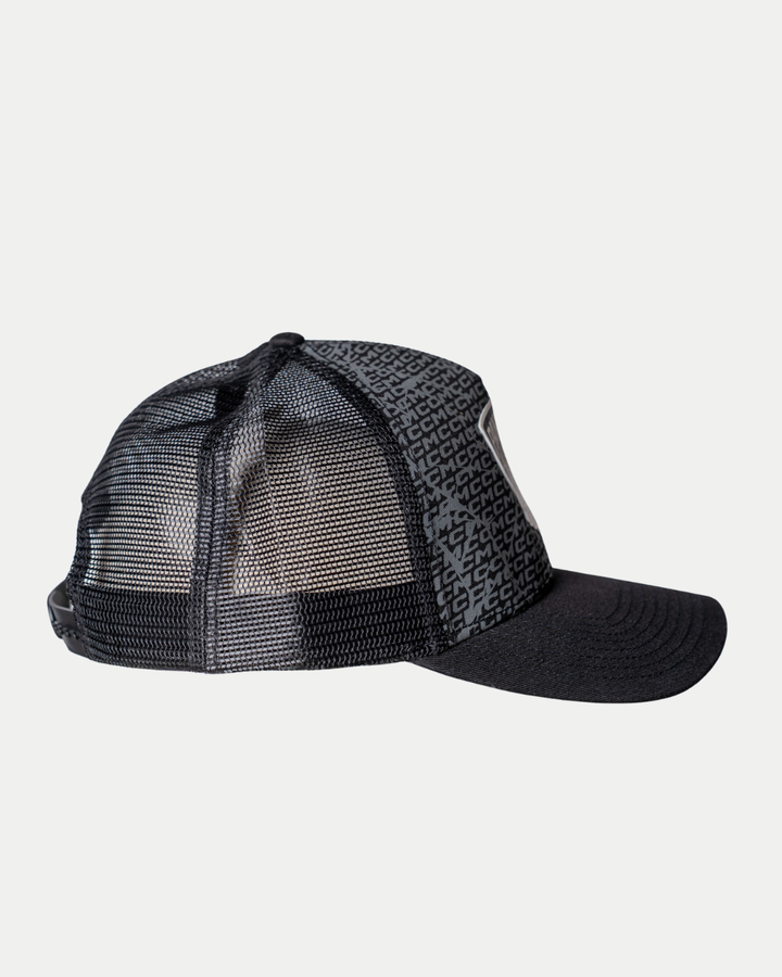 The Panthersland Nottingham Panthers 25-26 CCM Black Mesh Back Trucker features a curved brim, a patterned front panel, and see-through mesh back panels. Displayed from a side angle on a plain background.
