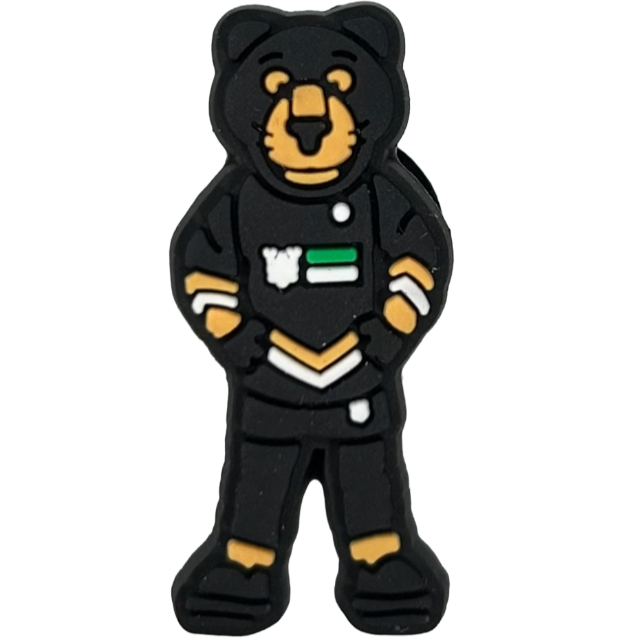The Paws Croc Charm by Panthersland features a cartoon bear in a firefighter uniform with yellow trim, white and green details, standing hands on hips—an ideal mascot accessory for Nottingham Panthers fans.