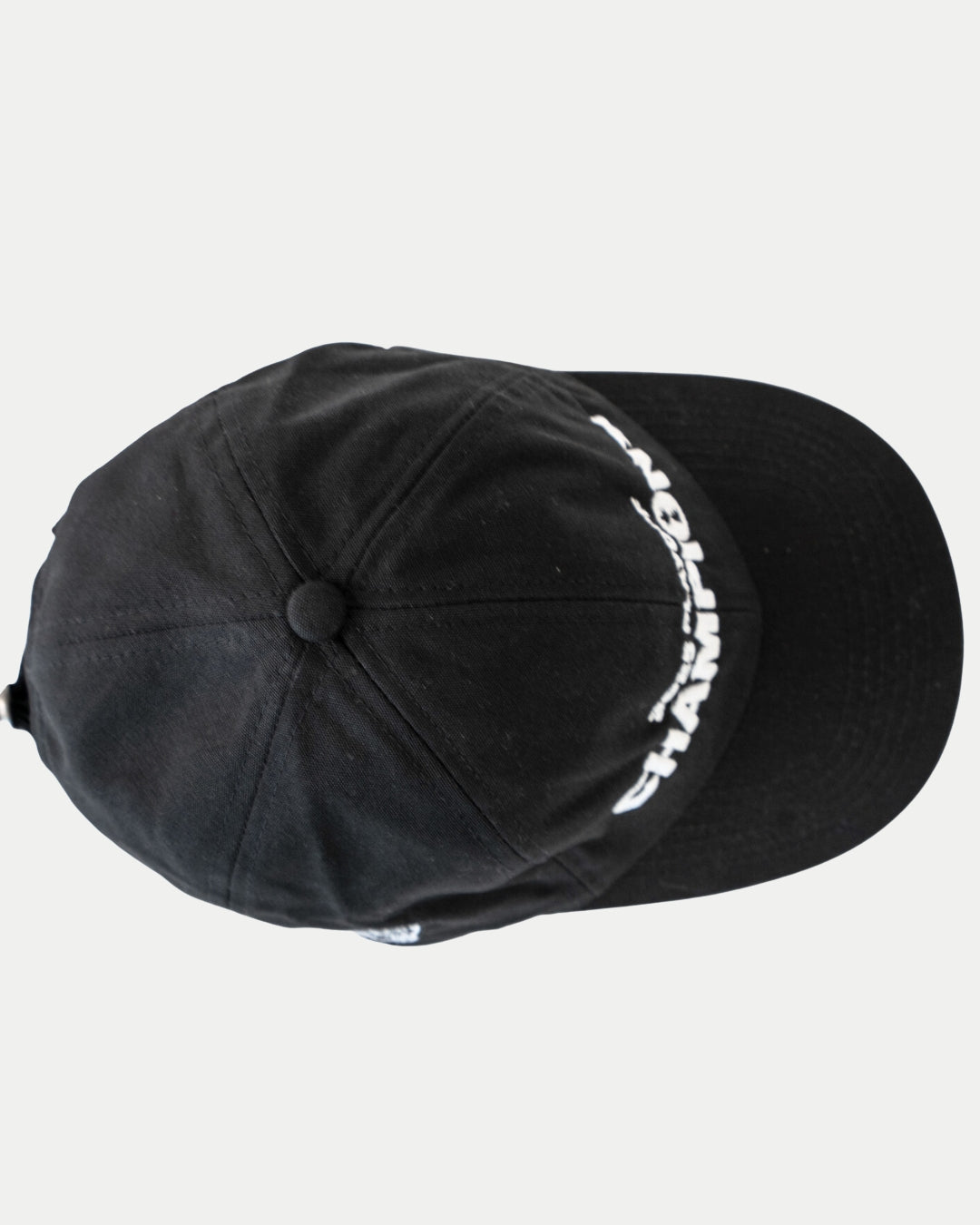 The Nottingham Panthers Made To Order Playoff Champions Panthers 2025 Organic Cotton Dad Cap in black & white, seen from above, features white embroidery along the right brim and crown, crafted from 100% organic cotton on a plain white background.