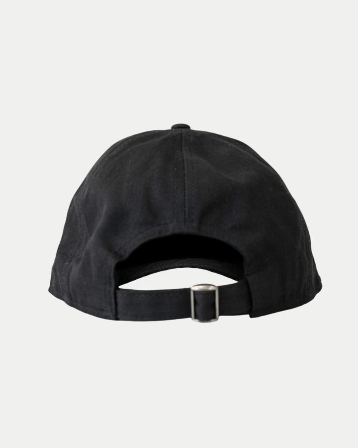The Nottingham Panthers Made To Order Playoff Champions Panthers 2025 Organic Cotton Dad Cap in black & white is shown from the back, highlighting its adjustable strap with metal buckle. Crafted from 100% organic cotton and set against a plain white background.