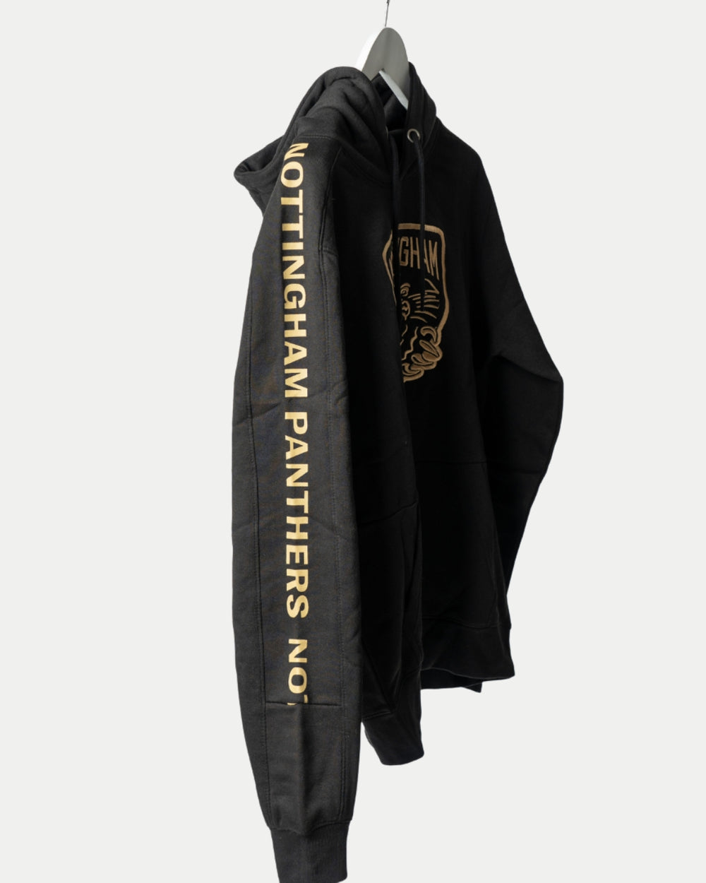 The Nottingham Panthers Golden Twill Hockey Club Hoodie Junior is a black hoodie featuring gold NOTTINGHAM PANTHERS NO.1 text down the sleeve and a bold gold panther logo with NOTTINGHAM on the chest.