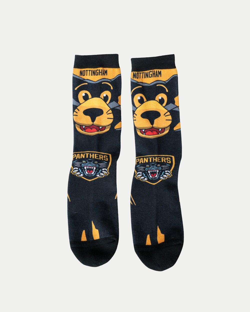 The Nottingham Panthers Paws Socks by Nottingham Panthers are black with a cartoon panther face with yellow accents, Nottingham at the top, and a snarling Panthers logo near the toes.