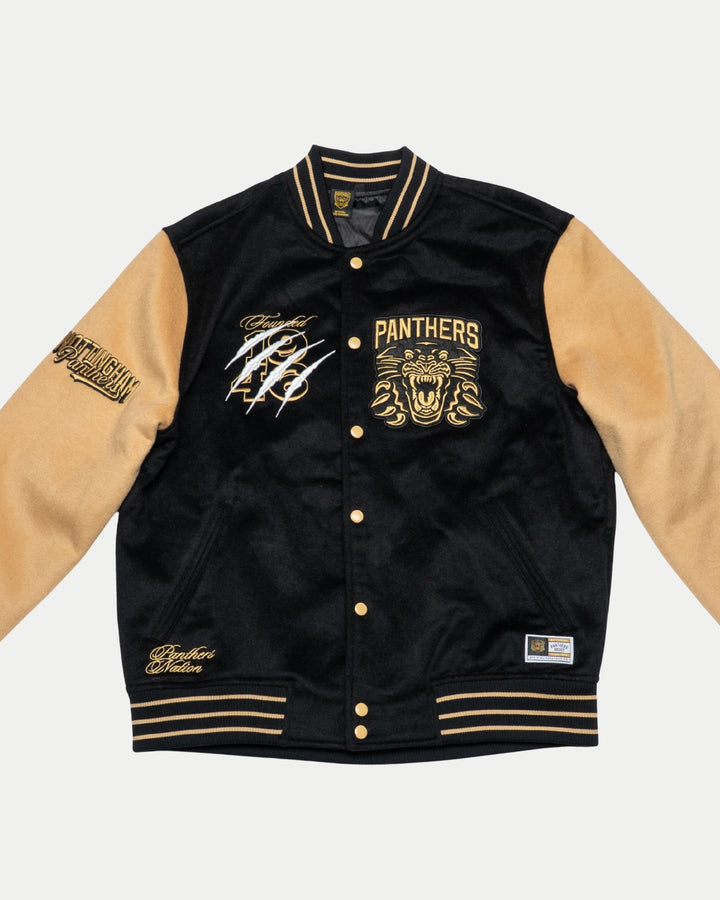The Panthersland Nottingham Panthers Varsity Jacket Black/Gold 25-26 features PANTHERS and a roaring panther on the chest, gold buttons, tan sleeves, striped cuffs, bold patches, and white signatures—an iconic fan piece.