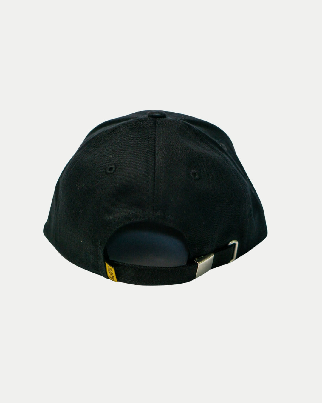 The Nottingham Panthers Signature Cap 25-26 by Panthersland is shown from the back with an adjustable strap, metal buckle, and yellow tag—ideal fan merchandise—set against a plain white background.