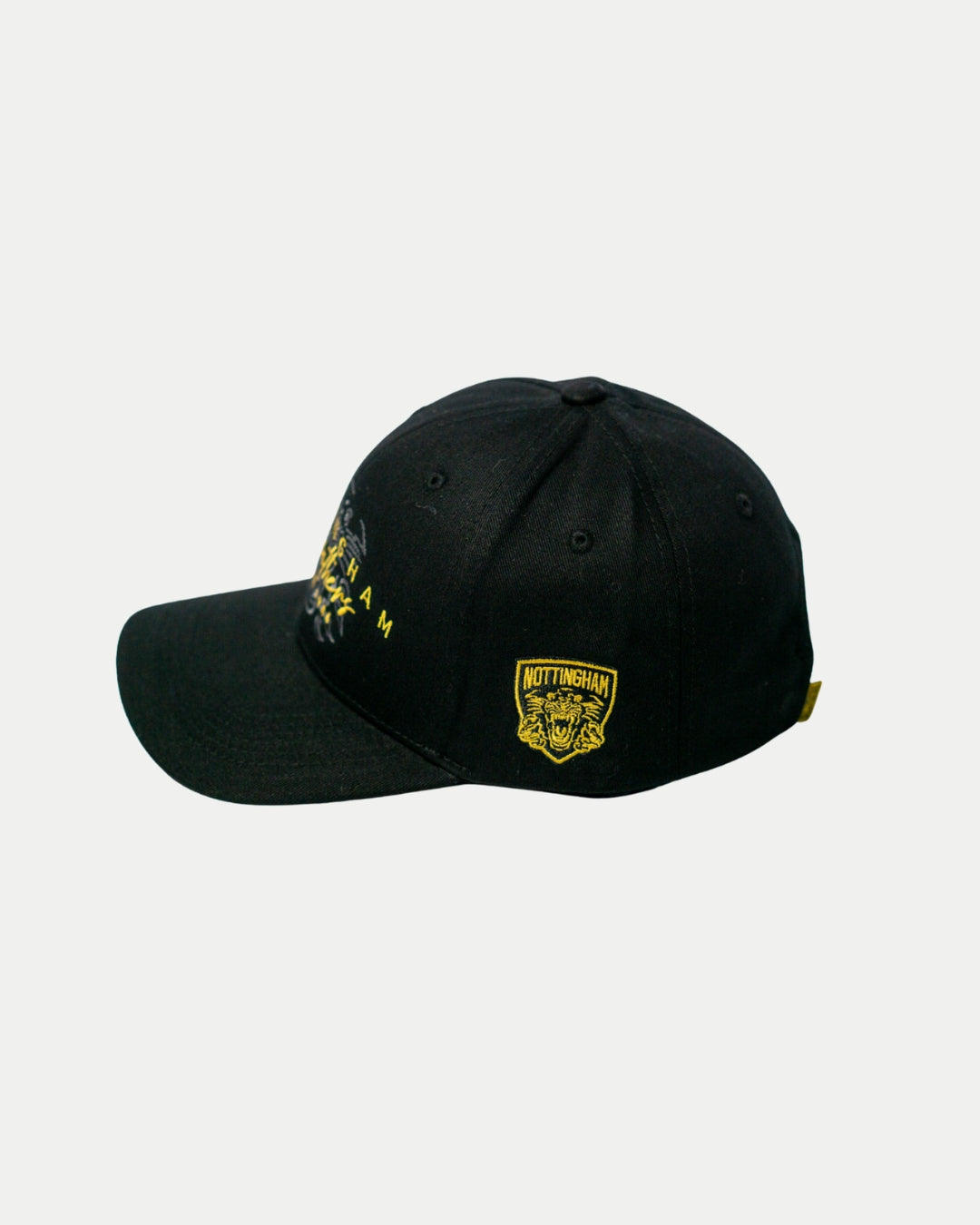 The Panthersland Nottingham Panthers Signature Cap 25-26 is black with yellow embroidered text and a Nottingham crest patch. Displayed at an angle on a white background, its perfect for any fan.