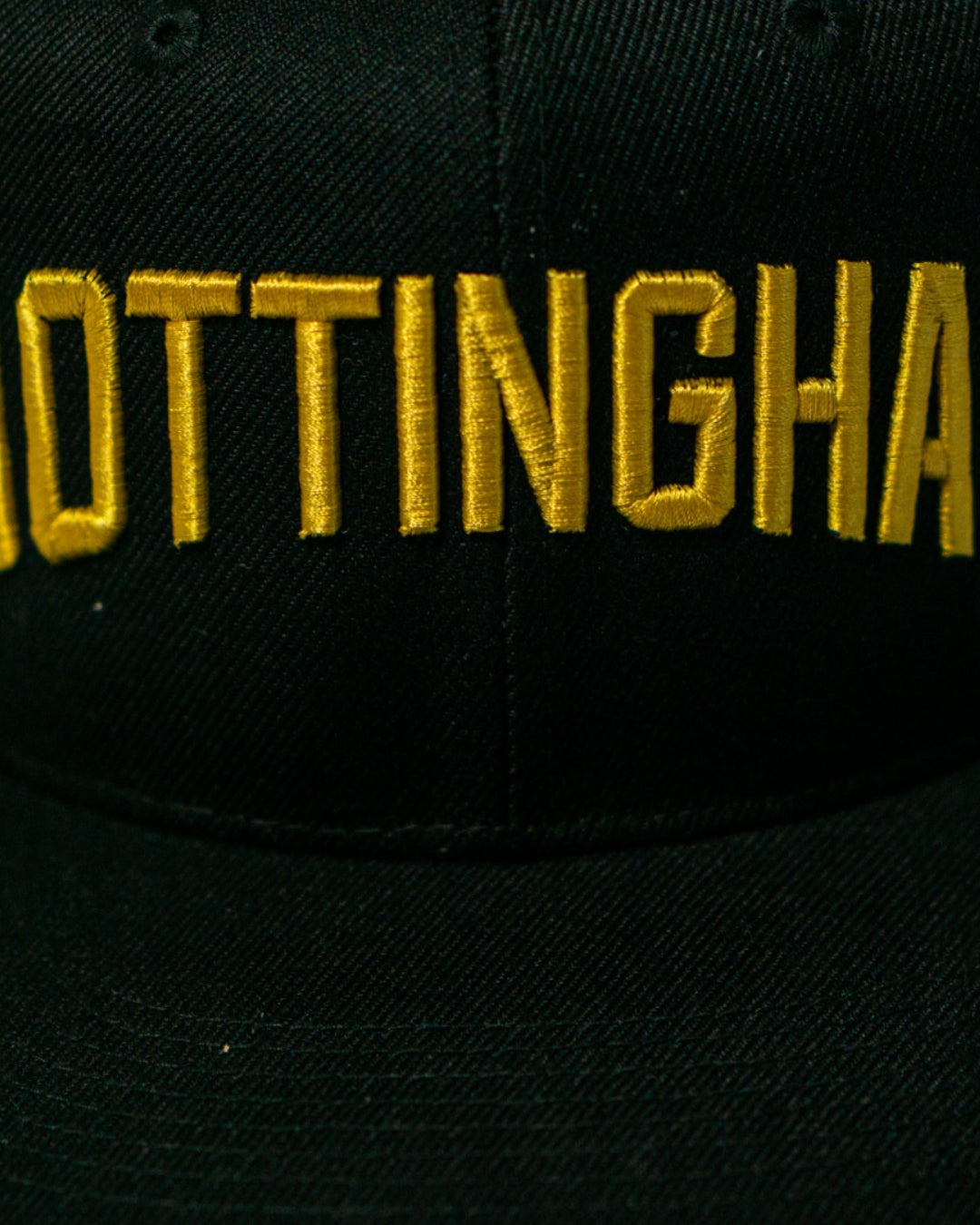 The Panthersland Nottingham Panthers 25-26 Big City Text Snapback Cap features bold, partially visible NOTTINGHAM embroidery in large yellow letters across the front for a standout look.