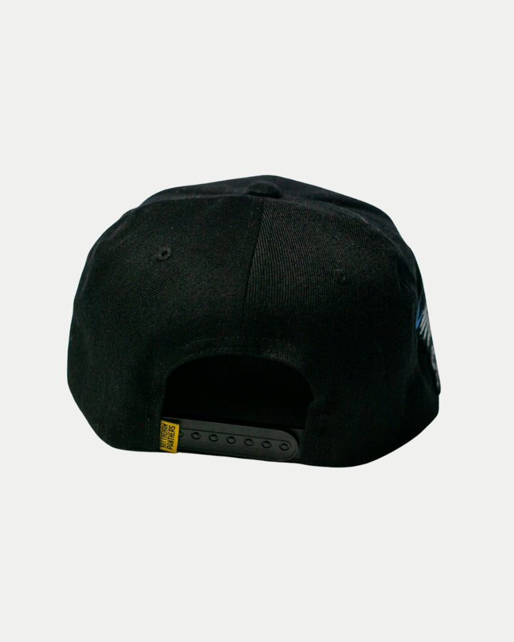 The Nottingham Panthers 25-26 Four Stripe Flatbrim Cap by Panthersland is shown from the back, featuring an adjustable strap, a small yellow tag on the left side, and a subtle Panthers crest accent near the strap against a plain background.
