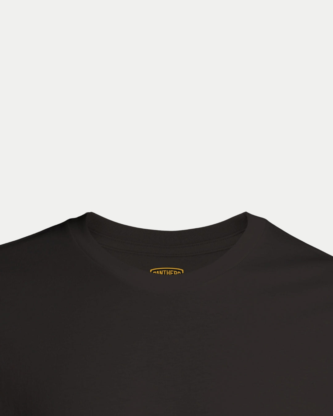 Close-up of the neckline on a Nottingham Panthers Made To Order Champions Elite League Playoffs 2025 T-shirt in black, showing a small yellow INNER label inside the collar against a white background.