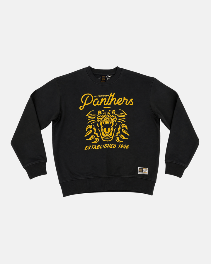 Introducing the Panthersland 26-27 Black Script Crewneck: this black long sleeve sweatshirt showcases a bold yellow roaring panther graphic, with “Nottingham Panthers” text above and “Established 1946” below. Finished with a small rectangular patch by the lower hem, it’s an ideal choice for hockey fans.