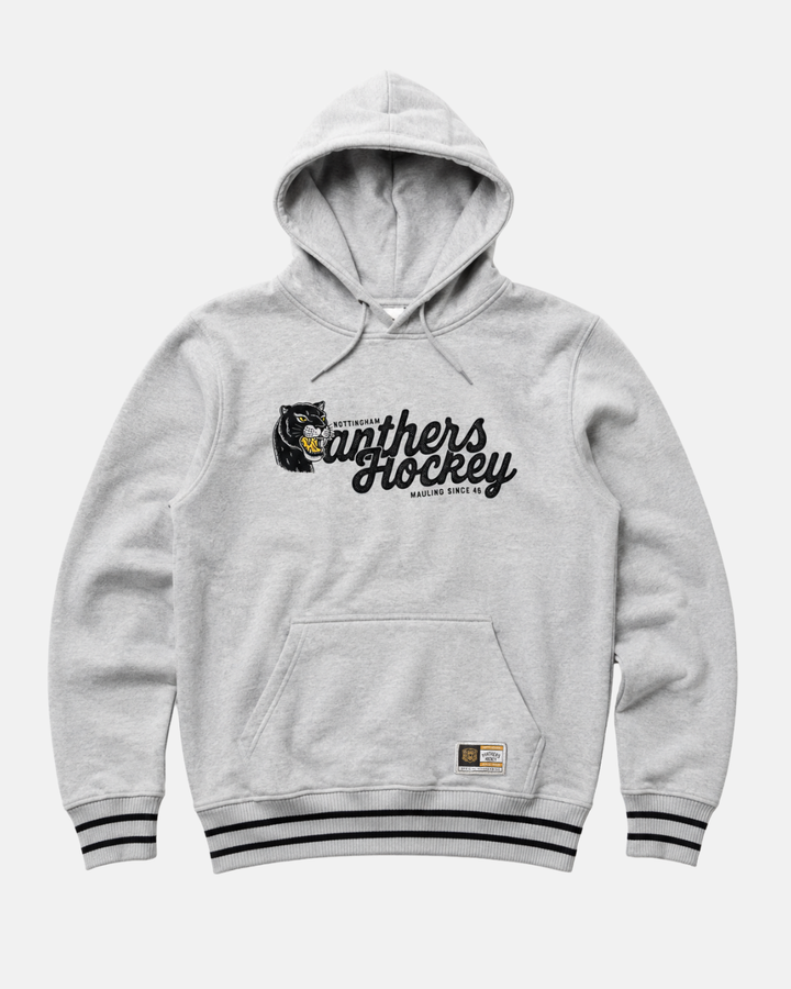The 26-27 Grey Panther Hoodie from Panthersland is a light gray Nottingham Panthers hoodie that showcases bold “Panthers Hockey” text and a striking panther graphic across the chest. It features a front pocket, black-striped cuffs and hem, plus a small stitched patch near the bottom hem for added detail.