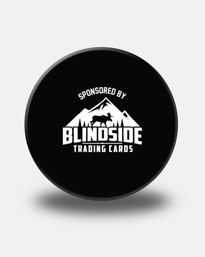 Black Nottingham Panthers Replica Match Puck from Panthersland featuring a logo with mountains, a moose silhouette, and the words “Sponsored by Blindside Trading Cards” in white text. This puck casts a soft shadow on a light background—an ideal addition to any fan’s collection.