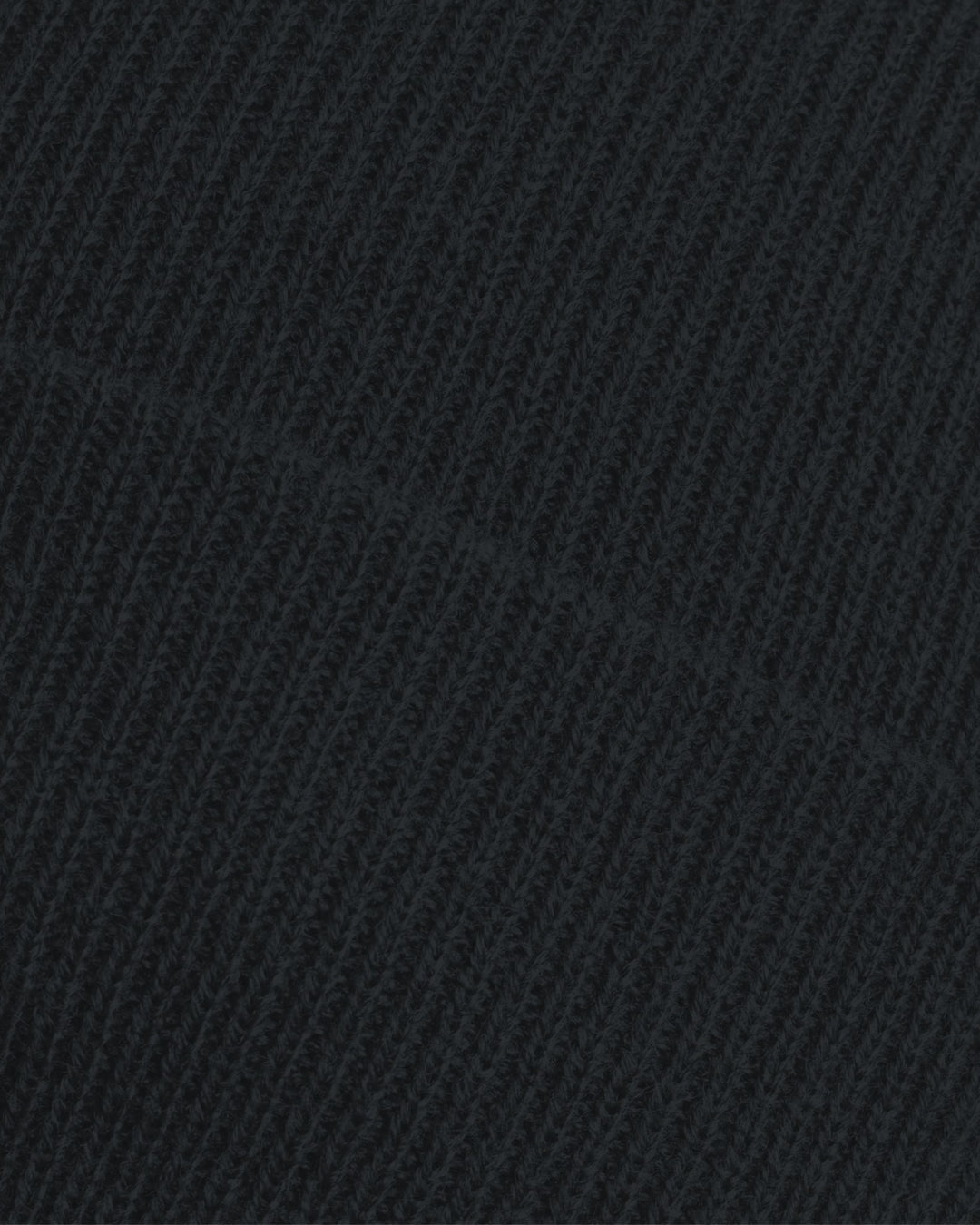 Close-up of the ribbed knit fabric on the Nottingham Panthers Made To Order Logo Cuffed Beanie Black, showing detailed loops, stitches, and a diagonal seam that highlight its thick acrylic texture.