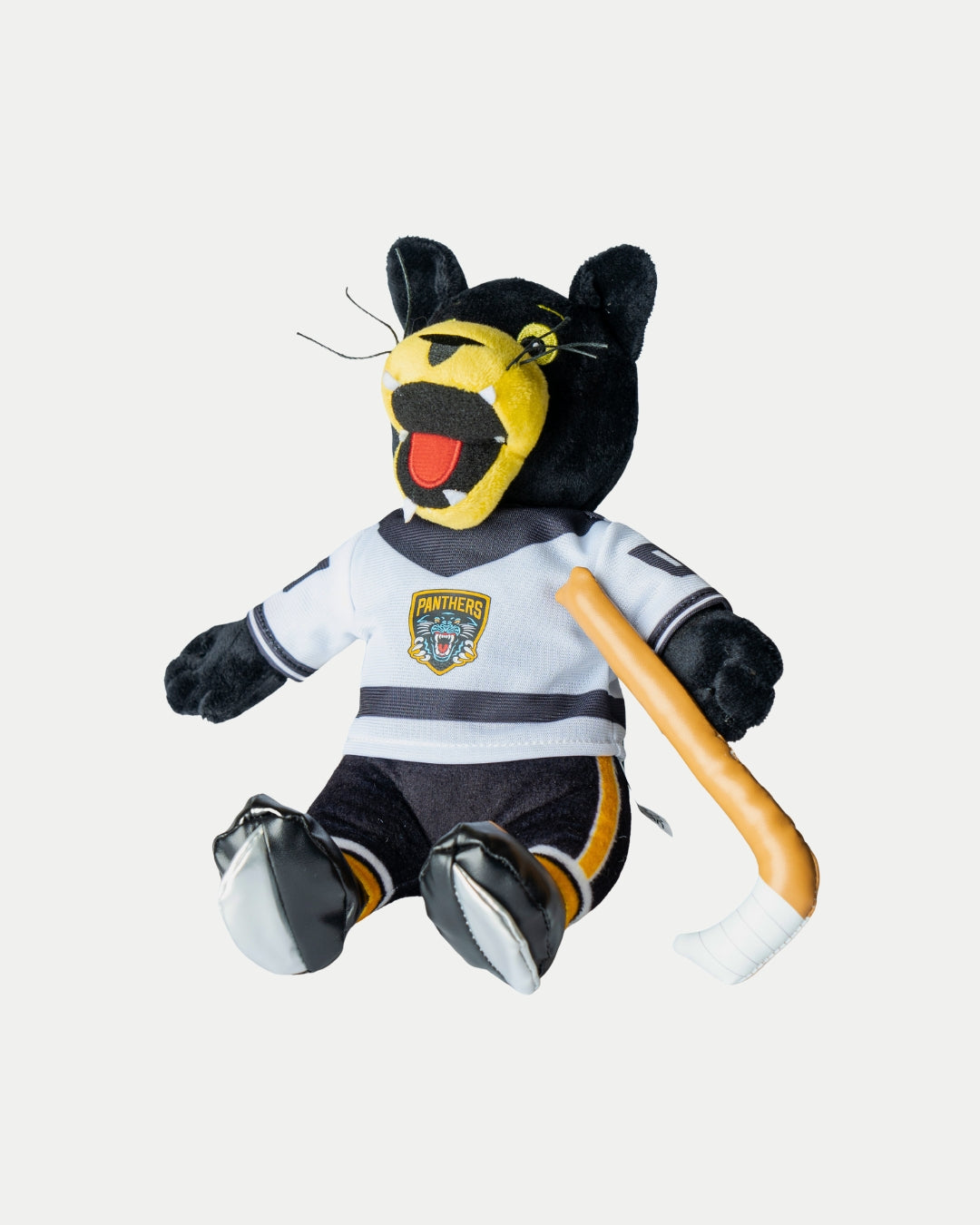 The Nottingham Panthers Paws Plush White Jersey by Nottingham Panthers features a black panther plush in a white team jersey, holding a hockey stick and sitting upright against a plain white background.