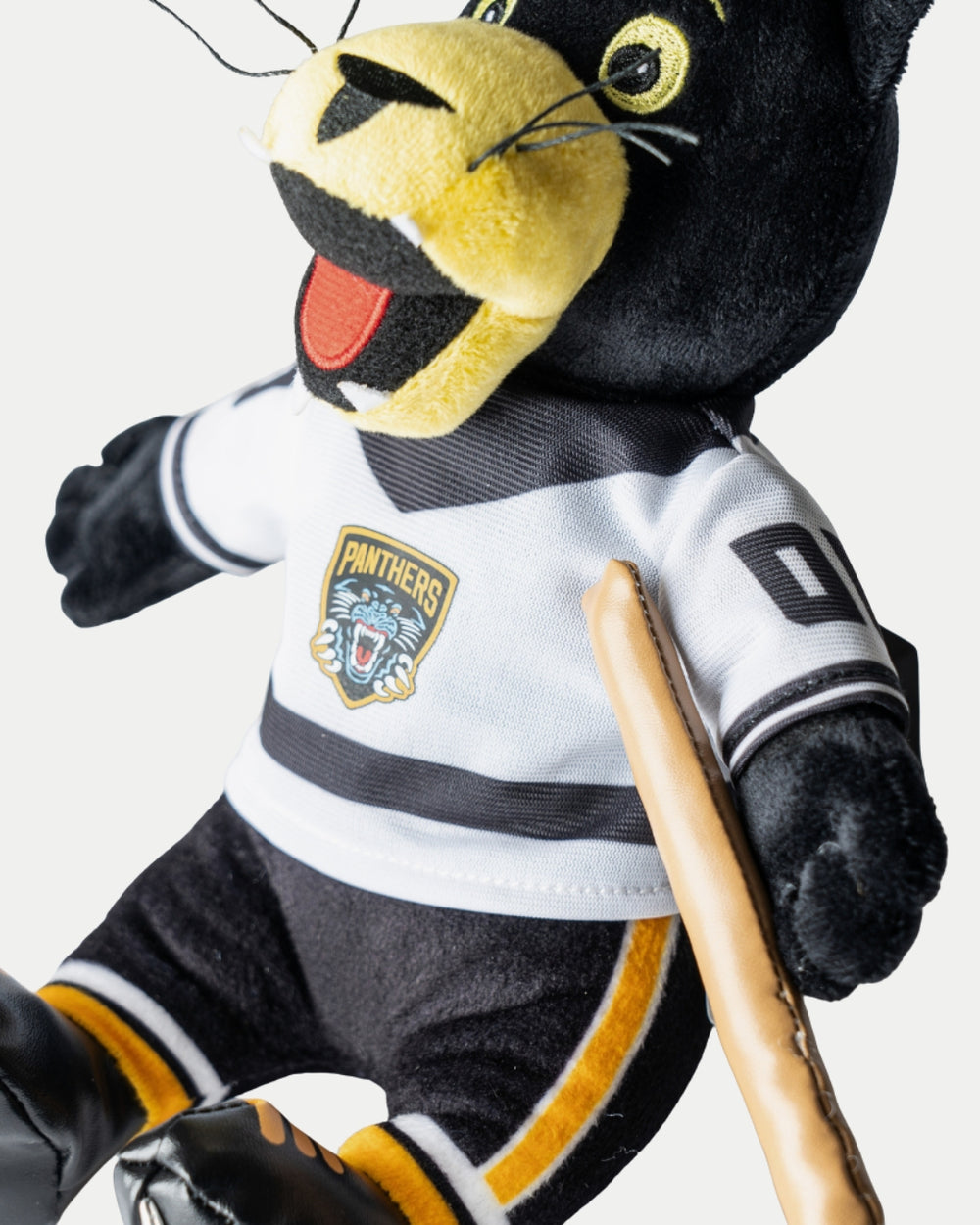 The Nottingham Panthers Paws Plush White Jersey by Nottingham Panthers features a plush panther in a white team jersey with logo and black accents, holding a hockey stick—an adorable collectible with bright yellow facial highlights.