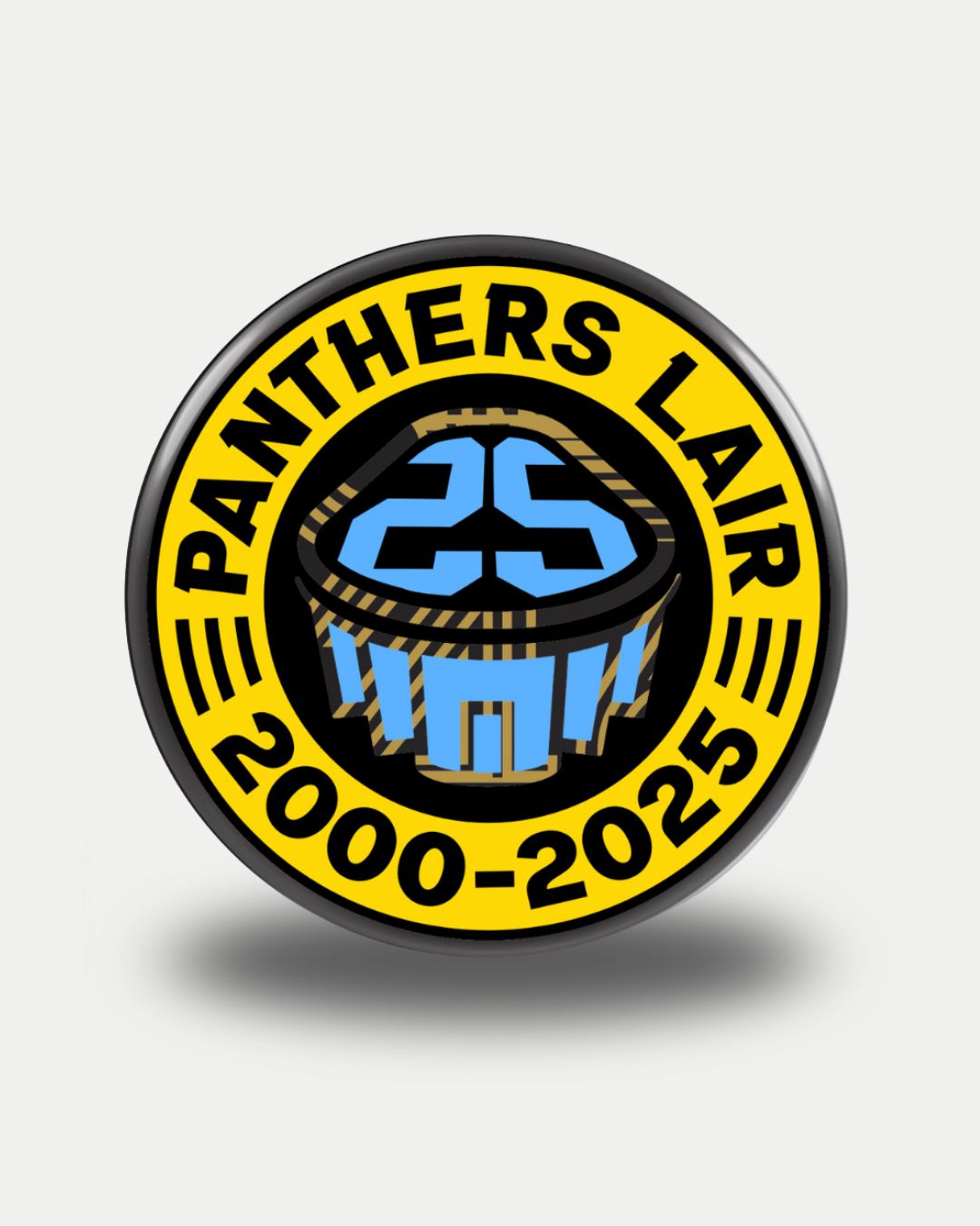 The Nottingham Panthers Panthers Lair 25th Anniversary Puck features a round design with PANTHERS LAIR at the top, 2000-2025 below in yellow, and a blue and black cupcake topped with 25 at the center.